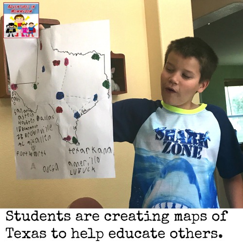 holding up map for Texas geography unit